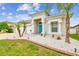 Charming home featuring a three-car garage, manicured front yard with unique landscaping, and a bright blue front door at 6843 Boulder Run Loop, Wesley Chapel, FL 33545