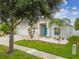 Beautiful home with blue door, manicured lawn, and meticulous landscaping at 6843 Boulder Run Loop, Wesley Chapel, FL 33545