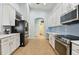 Updated kitchen with white cabinets, stainless steel appliances including a refrigerator and range at 6843 Boulder Run Loop, Wesley Chapel, FL 33545