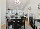 Open-concept kitchen with a breakfast nook features updated appliances, a chandelier, and ceramic tile flooring at 6843 Boulder Run Loop, Wesley Chapel, FL 33545