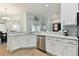 Bright kitchen features white cabinets, granite countertops, and stainless steel appliances at 6843 Boulder Run Loop, Wesley Chapel, FL 33545