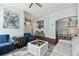 Comfortable living room with stylish decor, including an octopus painting and modern furniture with dark-wood flooring at 6843 Boulder Run Loop, Wesley Chapel, FL 33545