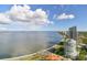 Aerial view of a luxury highrise building with water and city views at 2910 W Barcelona St # 802, Tampa, FL 33629