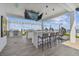 Modern outdoor kitchen with bar seating and a TV at 2910 W Barcelona St # 802, Tampa, FL 33629