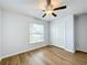 Spacious bedroom with hardwood floors, ceiling fan, and double door closet at 13336 Great Plains Dr, Riverview, FL 33579
