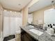 Bathroom with shower/tub combo, granite countertop, and white cabinets at 13336 Great Plains Dr, Riverview, FL 33579