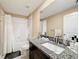 Bathroom with bathtub, granite countertop, and white cabinets at 13336 Great Plains Dr, Riverview, FL 33579