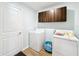 Laundry room with washer, dryer, and upper cabinets at 13336 Great Plains Dr, Riverview, FL 33579