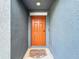Inviting orange front door with a welcoming mat at 13336 Great Plains Dr, Riverview, FL 33579