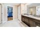 Double vanity bathroom with granite countertops and large walk-in closet at 13336 Great Plains Dr, Riverview, FL 33579