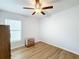 Bedroom with ceiling fan, wood-look floors, and dresser at 13336 Great Plains Dr, Riverview, FL 33579