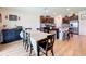 Kitchen and dining area with an island, dark brown cabinetry, and wood flooring at 13336 Great Plains Dr, Riverview, FL 33579