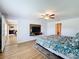 Spacious bedroom with wood-look floors, ceiling fan, and access to other rooms at 13336 Great Plains Dr, Riverview, FL 33579