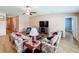 Bright living room featuring hardwood floors, comfortable seating, and a large TV at 13336 Great Plains Dr, Riverview, FL 33579