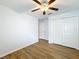 Bedroom with ceiling fan, wood-look floors, and double door closet at 13336 Great Plains Dr, Riverview, FL 33579