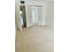 Bright bedroom with mirrored closet doors and access to hallway at 1655 S Highland Ave # F133, Clearwater, FL 33756