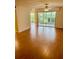 Bright living room with laminate floors and sliding doors to patio at 1655 S Highland Ave # F133, Clearwater, FL 33756
