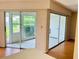 Bedroom with access to two lanais and backyard view at 1655 S Highland Ave # F133, Clearwater, FL 33756