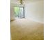 Bright bedroom featuring carpet flooring and sliding doors to balcony at 1655 S Highland Ave # F133, Clearwater, FL 33756