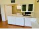 Kitchen features white cabinets, a double sink, and ample counter space at 1655 S Highland Ave # F133, Clearwater, FL 33756