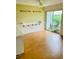 Bright dining area with wood-look floors and sliding glass doors at 1655 S Highland Ave # F133, Clearwater, FL 33756