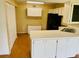 Kitchen with white cabinets, black appliances, and a breakfast bar at 1655 S Highland Ave # F133, Clearwater, FL 33756
