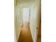 Light and bright hallway with wood-look floors leading to bedrooms and other rooms at 1655 S Highland Ave # F133, Clearwater, FL 33756