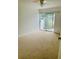 Spacious bedroom with carpet, ceiling fan, and sliding glass doors to patio at 1655 S Highland Ave # F133, Clearwater, FL 33756