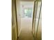 Bedroom with mirrored closet and view into main living area at 1655 S Highland Ave # F133, Clearwater, FL 33756