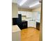 Kitchen with black appliances and white cabinets at 1655 S Highland Ave # F133, Clearwater, FL 33756
