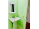 Simple bathroom with pedestal sink and light green walls at 1655 S Highland Ave # F133, Clearwater, FL 33756