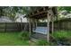 Backyard with wooden swing bench under pergola at 2226 S Kings Ave, Brandon, FL 33511