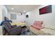 Bedroom with a bed, recliner, and daybed, and a large red rose painting at 2226 S Kings Ave, Brandon, FL 33511