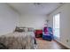Cozy bedroom with a ceiling fan, wood floors, and a sitting area with a recliner at 35070 Smoketree Ln, Dade City, FL 33523