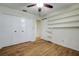 A bright bedroom with wood floors, built-in shelving, and a double-door closet at 35070 Smoketree Ln, Dade City, FL 33523