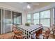 Bright breakfast nook featuring wood-look floors, lots of windows and sliding glass door with access to the lanai at 35070 Smoketree Ln, Dade City, FL 33523