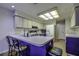Bright kitchen with barstool seating at a peninsula, lots of counter space, and a refrigerator at 35070 Smoketree Ln, Dade City, FL 33523