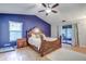Spacious main bedroom with wood floors, a ceiling fan, and sliding glass doors leading to the patio at 35070 Smoketree Ln, Dade City, FL 33523