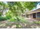 Landscaped backyard with shaded seating area at 35070 Smoketree Ln, Dade City, FL 33523