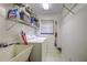 Laundry room with washer, dryer, and shelving at 35070 Smoketree Ln, Dade City, FL 33523