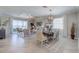 Bright dining area with a large table and access to the living room at 7961 Lakes Edge Ln, Port Charlotte, FL 33981