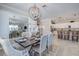 Elegant dining area with a stunning chandelier and kitchen views at 7961 Lakes Edge Ln, Port Charlotte, FL 33981
