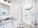 Bathroom features granite countertop, white cabinets, and walk-in shower at 18390 Fremont Ave, Port Charlotte, FL 33954