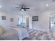 Bright primary bedroom with wood-look floors, and access to bathroom at 18390 Fremont Ave, Port Charlotte, FL 33954