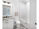 Clean bathroom, featuring a bathtub, granite countertop, and white cabinets at 18390 Fremont Ave, Port Charlotte, FL 33954