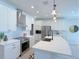 Bright and airy kitchen with white cabinetry, stainless steel appliances and an island at 18390 Fremont Ave, Port Charlotte, FL 33954