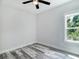 Bright bedroom with ceiling fan and wood-look floors at 18390 Fremont Ave, Port Charlotte, FL 33954