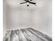 Simple bedroom with ceiling fan and wood-look floors at 18390 Fremont Ave, Port Charlotte, FL 33954