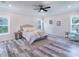 Spacious primary bedroom with wood-look floors and lots of natural light at 18390 Fremont Ave, Port Charlotte, FL 33954