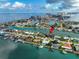 Gorgeous waterfront home with a dock, beautiful landscaping, and views of the bay and intercoastal waterway at 221 Howard Dr, Belleair Beach, FL 33786